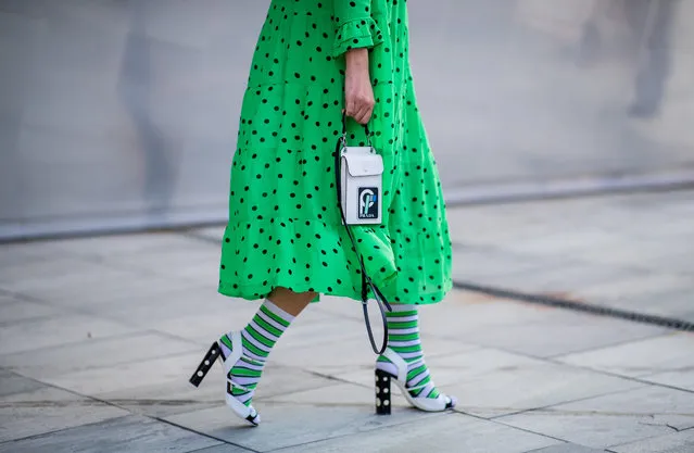 A guest wearing green dress, white heels, green socks, bag is seen outside Designers Remix during the Copenhagen Fashion Week Spring/Summer 2019 on August 9, 2018 in Copenhagen, Denmark. (Photo by Christian Vierig/Getty Images)