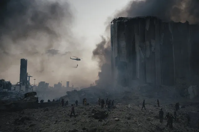 In this image released by World Press Photo, Thursday April 15, 2021, by Lorenzo Tugnoli, Contrasto, for The Washington Post, part of a series titled Port Explosion in Beirut, which won first prize in the Spot News Stories category, shows Firefighters work to put out the fires that engulfed warehouses in Beirut, Lebanon, on August 4, 2020, after a massive explosion in the port. Up to ten firefighters died in the blast. (Photo by Lorenzo Tugnoli, Contrasto, for The Washington Post, World Press Photo via AP Photo)