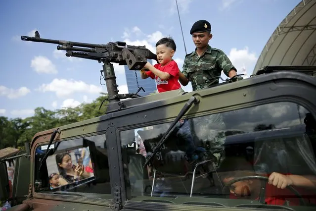 Children play in a military vehicle during the Children's Day celebration in Bangkok, Thailand January 9, 2016. (Photo by Jorge Silva/Reuters)