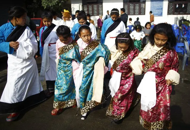 Tibetan girls dressed in traditional attire arrive to take part in the function organised to mark Losar or the Tibetan New Year at Tibetan Refugee Camp in Lalitpur February 19, 2015. (Photo by Navesh Chitrakar/Reuters)