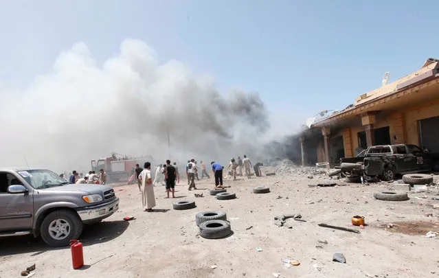 Libyans gather at the scene following a car bomb attack in al-Gharbiat in Sirte, Libya August 18, 2016. (Photo by Ismail Zitouny/Reuters)