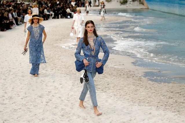 Models present creations by German designer Karl Lagerfeld as part of his Spring/Summer 2019 women's ready-to-wear collection show for fashion house Chanel at the Grand Palais transformed as a beach scene during Paris Fashion Week in Paris, France, October 2, 2018. (Photo by Stephane Mahe/Reuters)