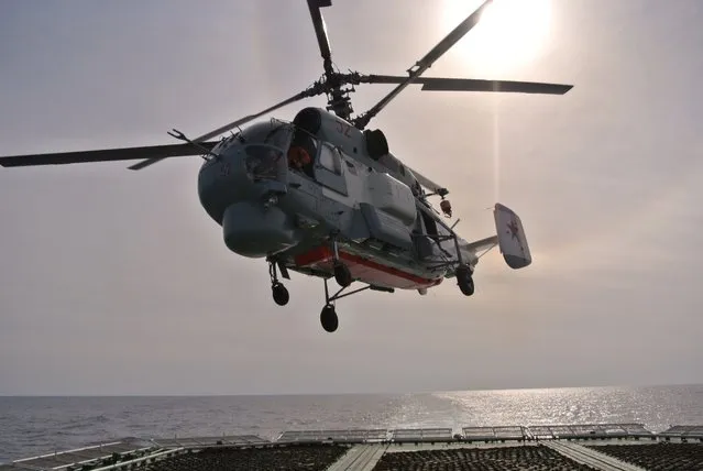 A Russian navy helicopter takes off from the deck of the Russian destroyer Vice Admiral Kulakov on patrol in eastern Mediterranean on Thursday, January 21, 2016. Russian warships equipped with an array of long-range missiles cruise off Syria's coast to back the air campaign in Syria and project Moscow's naval power in the Mediterranean. (Photo by Vladimir Isachenkov/AP Photo)