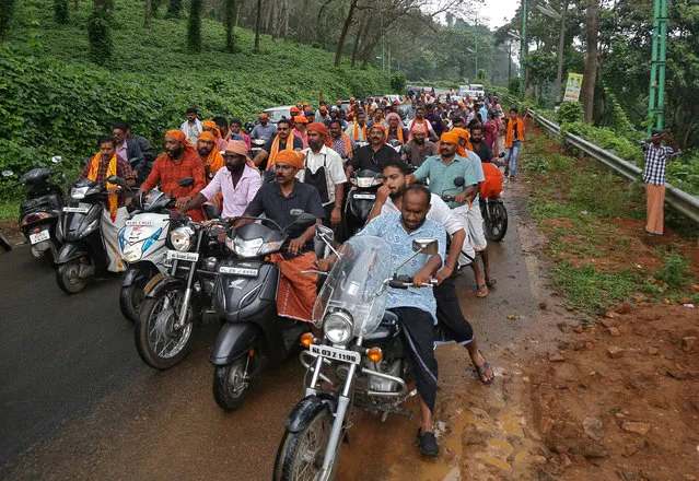 Hindu devotees take part in a motorcycle rally as part of a protest against the lifting of a ban by Supreme Court at Nilakkal Base camp in Pathanamthitta district in the southern state of Kerala, October 16, 2018. (Photo by Sivaram V/Reuters)