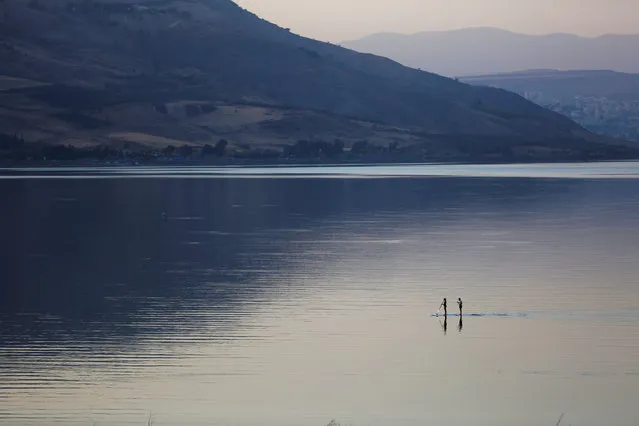 People paddle on a stand-up paddle board in the Sea of Galilee, northern Israel November 8, 2016. (Photo by Ronen Zvulun/Reuters)