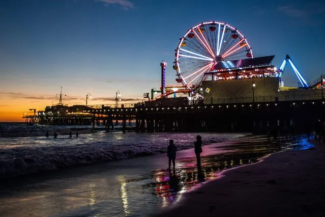 The Santa Monica Pier is pictured as the sun sets in Santa Monica, California on October 9, 2023. (Photo by Apu Gomes/AFP Photo)