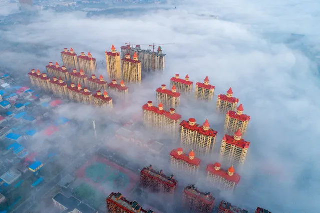 Aerial view of advection fog surrounding buildings on November 8, 2018 in Yuncheng, Shanxi Province of China. (Photo by Shang Jianzhou/VCG via Getty Images)