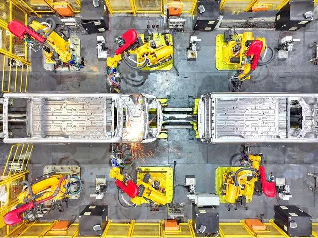 Busy production of new energy vehicles at a workshop in Ganzhou City, east China's Jiangxi Province on October 9, 2023. (Photo by Rex Features/Shutterstock)