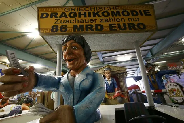 A papier mache caricature figure for a carnival float of Greek Prime Minister Alexis Tsipras (background) is prepared for the upcoming Rose Monday carnival parade in Mainz, Germany February 2, 2016. (Photo by Kai Pfaffenbach/Reuters)