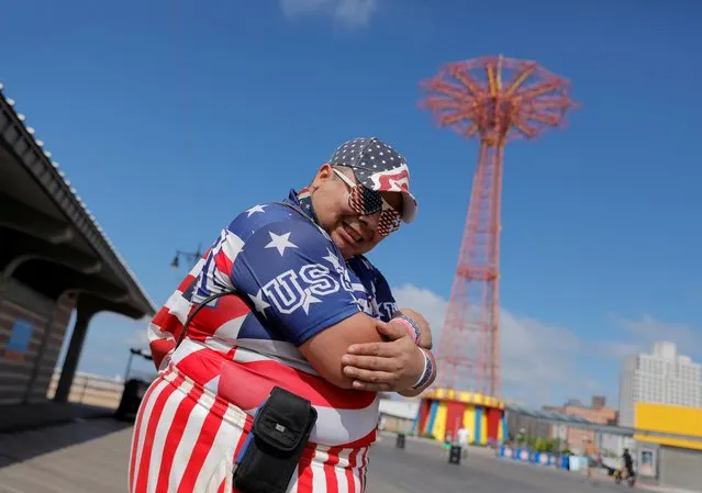 A person dressed in U.S. flags poses on the Coney Island Boardwalk on the Independence Day holiday in Brooklyn, New York City, New York, U.S., July 4, 2021. (Photo by Andrew Kelly/Reuters)