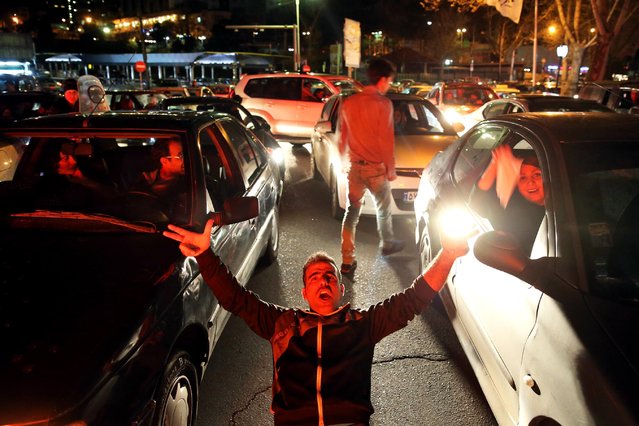 Iranians celebrate on a street in northern Tehran, Iran, Thursday, April 2, 2015, after Iran's nuclear agreement with world powers in Lausanne, Switzerland. (Photo by Ebrahim Noroozi/AP Photo)