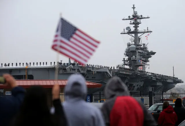 Family and friends watch as the USS Carl Vinson aircraft carrier departs on deployment from Naval Station North Island in Coronado, California, U.S. January 5, 2017. (Photo by Mike Blake/Reuters)