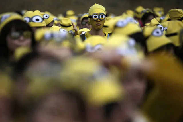Participants dressed as “minions” assemble at the start of the Minions Run charity event in Tokyo, Saturday, February 13, 2016. Some 10,000 runners enjoyed one kilometer run for the charities of children. (Photo by Eugene Hoshiko/AP Photo)