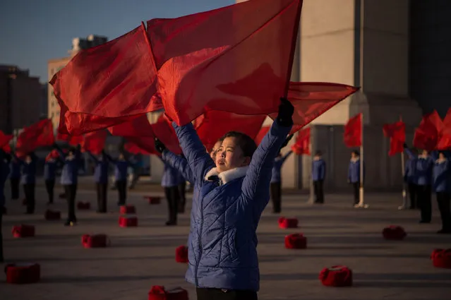 A propaganda troupe perform before the Arch of Triumph on the last day of the 200-day campaign in Pyongyang on December 15, 2016. North Korea wrapped up a 200-day mass mobilisation campaign aimed at boosting an economy struggling with upgraded UN sanctions imposed after its two nuclear tests this year. Coming hard on the heels of a similar 70-day campaign that ended in May, the 200-day version kicked off in early June, pushing extra hours and working weekends. (Photo by Kim Won-Jin/AFP Photo)