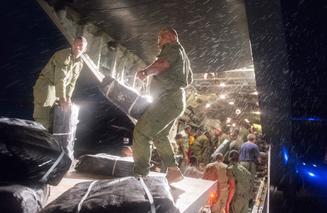 A handout image provided by the New Zealand Defence Force shows aid supplies being unloaded by Fijian soldiers from an Royal New Zealand Airforce C-130 Hercules plane in Suva, Fiji, 23 February 2016. Tool kits, generators, ration packs, water containers and chainsaws make up part of the New Zealand relief following Tropical Cyclone Winston. The death toll from the cyclone that hit Fiji over the weekend climbed to 29, local media reported ON 23 February. (Photo by Sam Shepherd/EPA/NZ Defence Force)