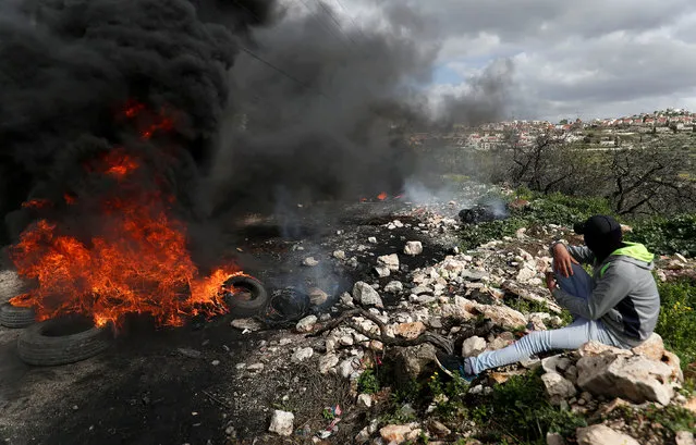 A Palestinian demonstrator rests during clashes with Israeli troops at a protest near the Jewish settlement of Qadomem, near Nablus in the Israeli-occupied West Bank February 8, 2019. (Photo by Mohamad Torokman/Reuters)