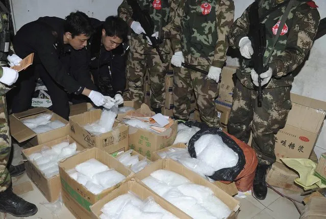 Police check seized crystal meth at Boshe village, Lufeng, Guangdong province, December 29, 2013. (Photo by Reuters/Stringer)