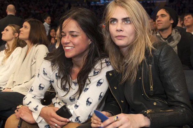 New York Knicks vs Detroit Pistons at Madison Square Garden: Actress Michelle Rodriguez and fashion model Cara Delevingne attend tonights game together seated in the front row. Michelle Rodriguez is visibly seen smoking what appears to be a E-Cigerette. As the game progressed Rodriguez appeared more and more intoxicated. January 7th, 2014. Credit Anthony J. Causi