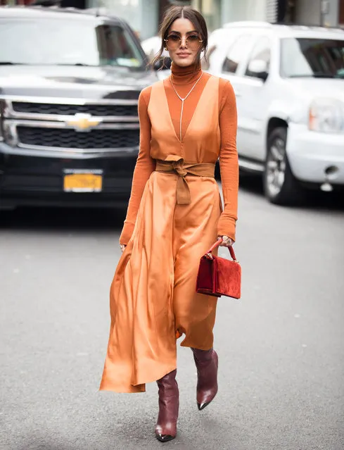 Camila Coelho poses outside of the Tibi show wearing a orange jumpsuit during New York Fashion Week on February 10, 2019 in New York City. (Photo by Donell Woodson/Getty Images)