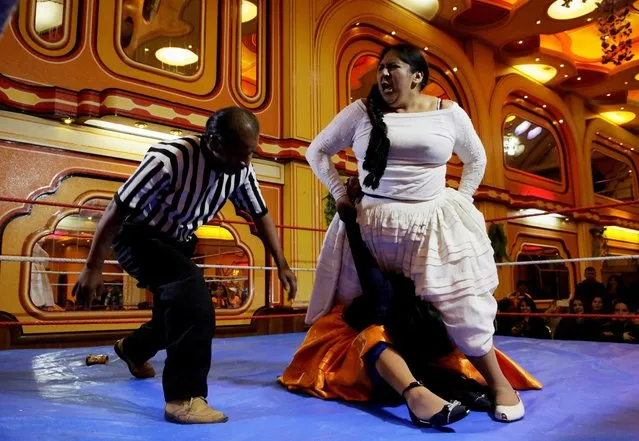 A Cholita (Andean woman) fighter makes a key to their opponent during a wrestling session at the Havana Hotel Cholet in El Alto, outskirts of La Paz, Bolivia, June 29, 2018. (Photo by David Mercado/Reuters)