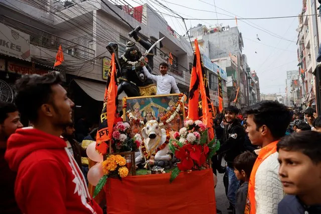 People celebrate the opening of the grand temple of the Hindu god Lord Ram in the northern town of Ayodhya, in a street in New Delhi, India on January 22, 2024. (Photo by Anushree Fadnavis/Reuters)