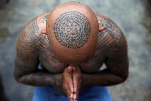 A devotee attends the religious tattoo festival at Wat Bang Phra Monastery, where devotees believe that their tattoos have mystical powers, in Nakhon Pathom province, Thailand, March 16, 2019. (Photo by Athit Perawongmetha/Reuters)