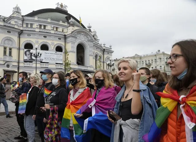 People take part in the annual Gay Pride parade, under the protection of riot police in Kyiv, Ukraine, Sunday, September 19, 2021. Around five thousand LGBT activists and associations paraded in the center of Kyiv. (Photo by Efrem Lukatsky/AP Photo)