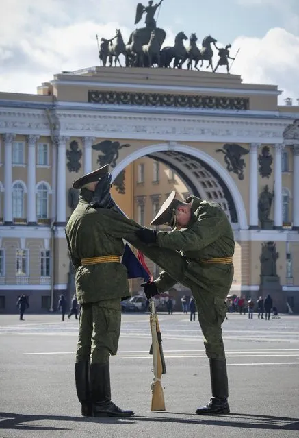 Russian honour guard soldiers warm up prior to a rehearsal for the Victory Day military parade which will take place at Dvortsovaya (Palace) Square on May 9 to celebrate 70 years after the victory in WWII, in St.Petersburg, Russia, Thursday, April 30, 2015. (Photo by Dmitry Lovetsky/AP Photo)