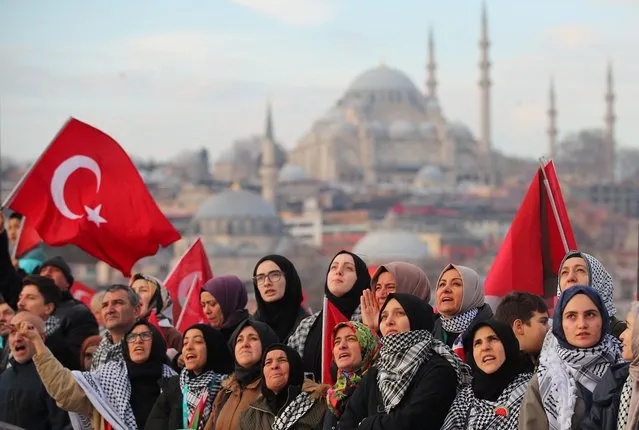 People gather over the Galata Bridge in solidarity with Palestinians following the first morning prayer of the New Year in Istanbul, Turkey on January 1, 2024. (Photo by Dilara Senkaya/Reuters)