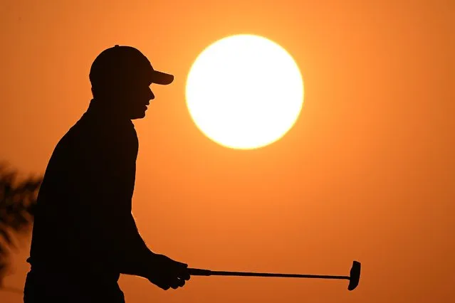 A silhouette of David Law of Scotland as he reacts after putting on the ninth green during Day One of the Bahrain Championship presented by Bapco Energies at Royal Golf Club on February 01, 2024 in Bahrain, Bahrain. (Photo by Ross Kinnaird/Getty Images)
