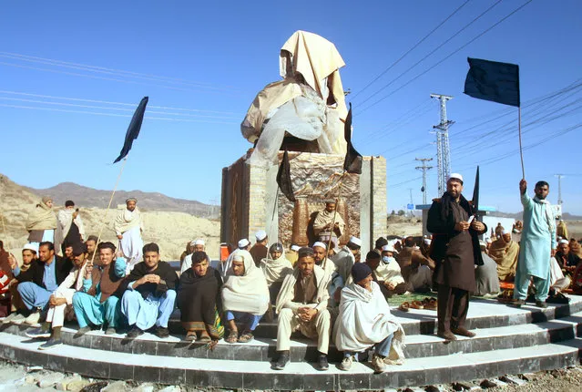 People hold black flags as they boycott voting during the general election as part of a protest against authorities for not fulfilling their demands, at Landi Kotal in Khyber Pakhtunkhwa province, Pakistan on February 8, 2024. (Photo by Reuters/Stringer)