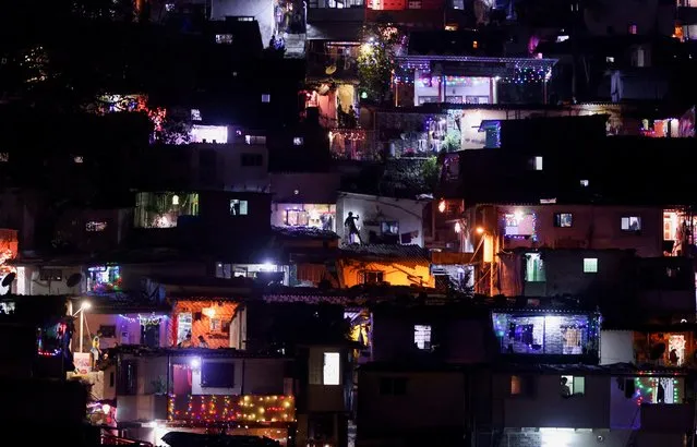 Houses are lit up with lanterns and lights as they celebrate the annual Hindu festival of Diwali at a slum in Mumbai, India, November 3, 2021. (Photo by Francis Mascarenhas/Reuters)
