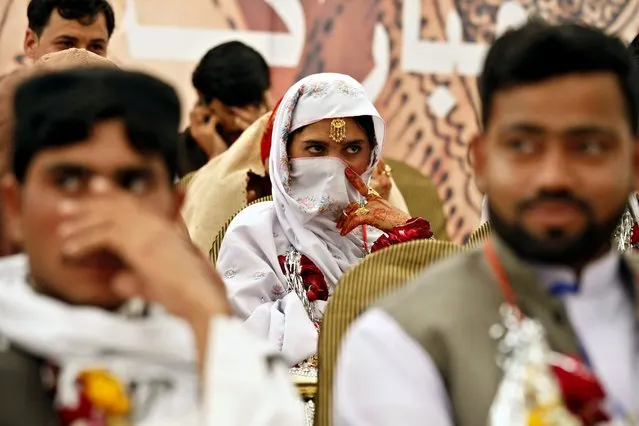 Pakistani brides and grooms attend a mass wedding ceremony in Peshawar, Pakistan, 22 March 2016. Imran Khan, the chairman of opposition political party that is also ruling the Khyber-Pakhtunkhwa province, Pakistan Tehrik-e-Insaf, had arranged the ceremony for some 45 couples belonging to poorer classes. (Photo by Bilawal Arbab/EPA)