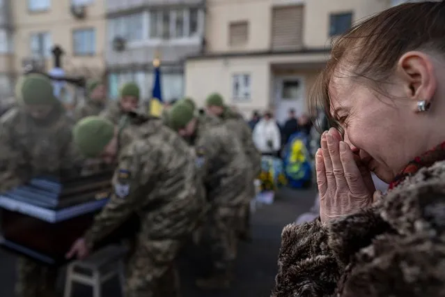 A woman cries during a funeral ceremony of Volodymyr Golubnychyi, Ukrainian senior lieutenant of 72nd Mechanized Brigade, in Kyiv, Ukraine, on Wednesday, February 28, 2024. Golubnychyi was killed during the fighting with Russian forces in Vodyane village, Avdiivka direction, on Feb. 19. (Photo by Evgeniy Maloletka/AP Photo)