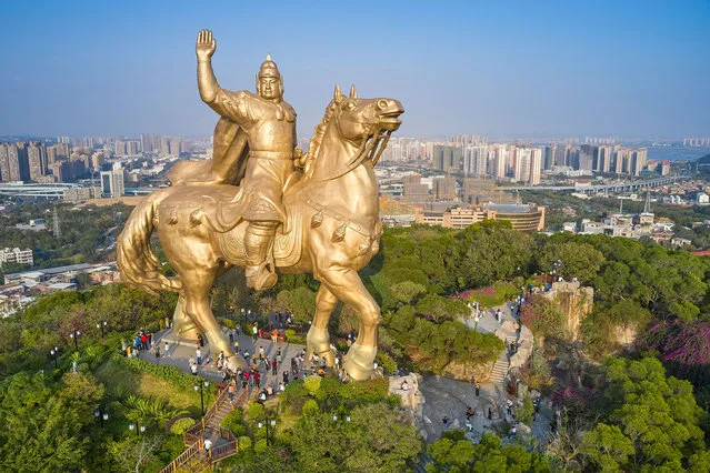 People visit the 38-meter-tall copper statue of Zheng Chenggong (aka Koxinga) atop Daping mountain on November 21, 2021 in Quanzhou, Fujian Province of China. (Photo by Xie Mingfei/VCG via Getty Images)