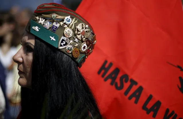 A woman wears a hat with medals and badges as she attends Victory Day celebrations in front of the Soviet Army monument in central Sofia, Bulgaria May 9, 2015. (Photo by Stoyan Nenov/Reuters)