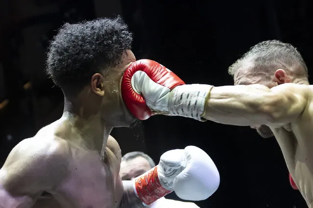 Angelo Pena (L) of Switzerland fights against Eduardo Costa Do Nascimento (R) of Brazil in the division Super Featherweight in Bern, Switzerland, 30 March 2024. (Photo by Anthony Anex/EPA)