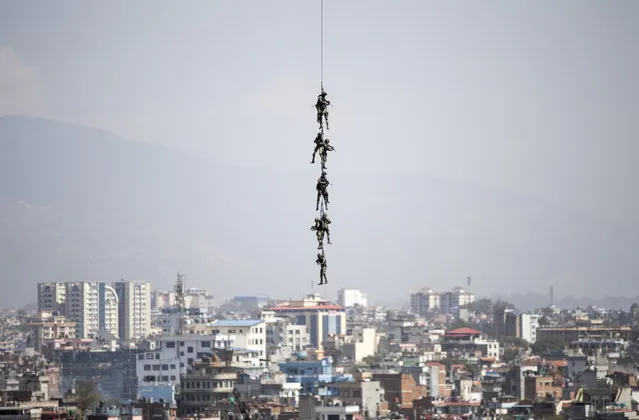 Nepalese Army commandos demonstrate a rescue operation as they rappel from a helicopter during the annual Army Day in Kathmandu, Nepal, 04 March 2019. The Nepalese army is active since 1744 and it has a size of about 95,000 infantry army and air service members. (Photo by Narendra Shrestha/EPA/EFE)