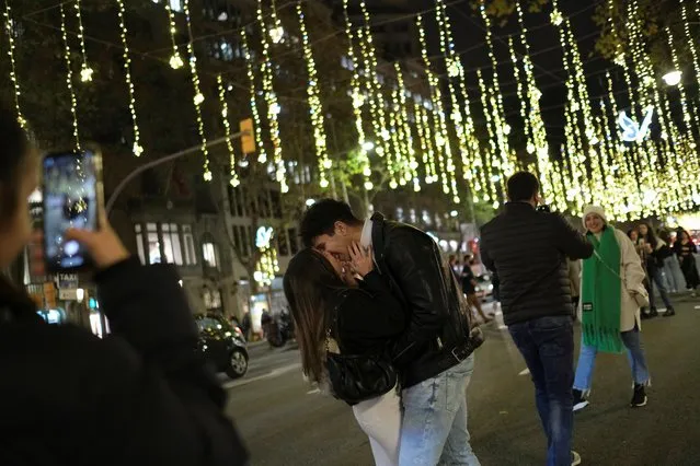 A couple kiss underneath Christmas illuminations on Passeig de Gracia street, to mark the start of the Christmas season, amid the coronavirus disease (COVID-19) pandemic, in Barcelona, Spain, December 7, 2021. (Photo by Nacho Doce/Reuters)