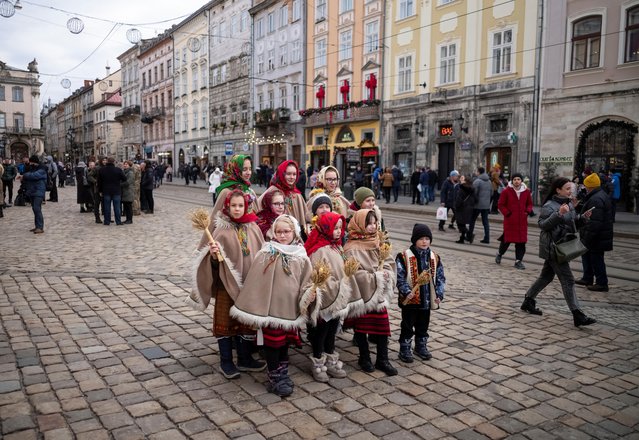 Children dressed in traditional costumes attend a celebration Orthodox Christmas in Lviv, Ukraine on January 6, 2022. (Photo by Gleb Garanich/Reuters)