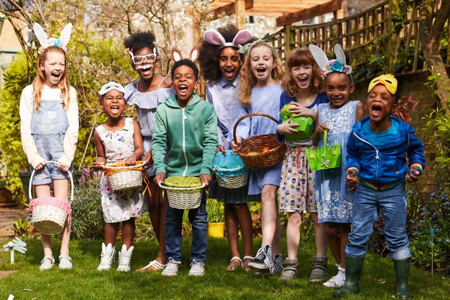 Group of children having fun on an Easter Egg Hunt, laughing and shouting, outside in the sun. (Photo by Looks Like Me/Getty Images)