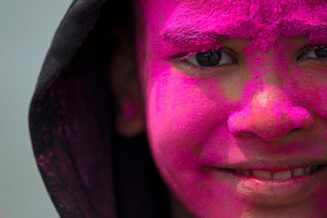 A boy has his face covered in colored powder during celebrations marking Holi, the Hindu festival of colors, in Kathmandu, Nepal, Sunday, March 24, 2024. (Photo by Niranjan Shrestha/AP Photo)