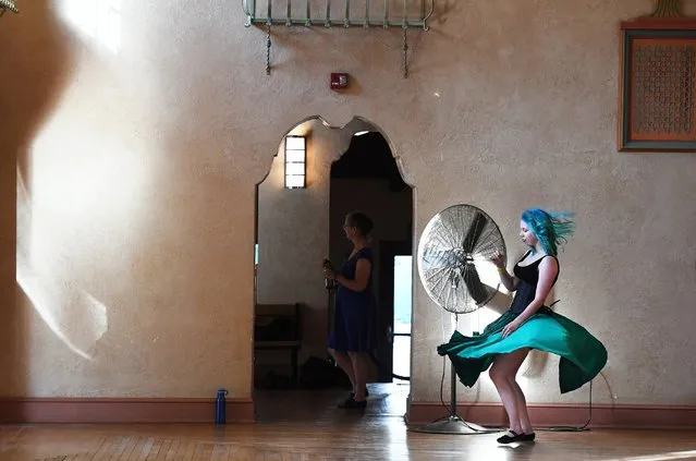 Jennie Harlow, 26, dances near a fan during a waltz dance event in the Spanish Ballroom at Glen Echo Park in Glen Echo, Md. on August 7, 2019. The building was built before air conditioning so dancers are cooled off by several fans positioned around the dance floor. (Photo by Matt McClain/The Washington Post)