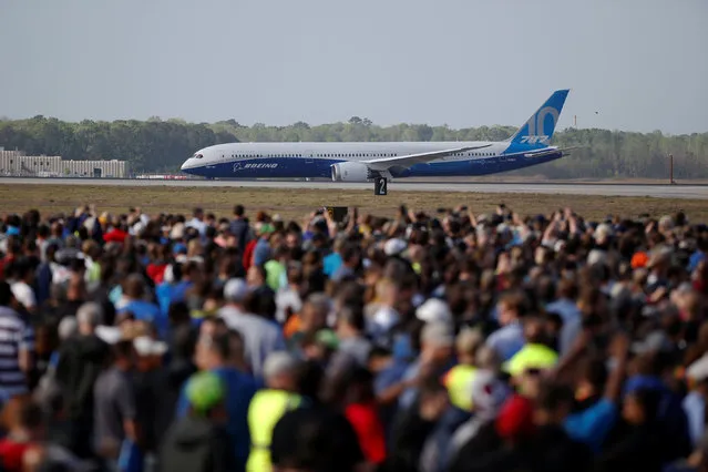 Employees and guest watch during the first flight ceremony of the new Boeing 787-10 Dreamliner at the Charleston International Airport in North Charleston, South Carolina, United States March 31, 2017. (Photo by Randall Hill/Reuters)