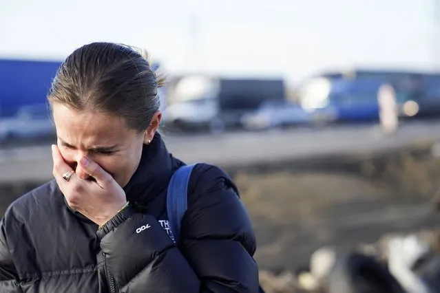 An American woman cries after crossing the border and fleeing the violence in Ukraine, in Medyka, Poland, February 24, 2022. (Photo by Bryan Woolston/Reuters)