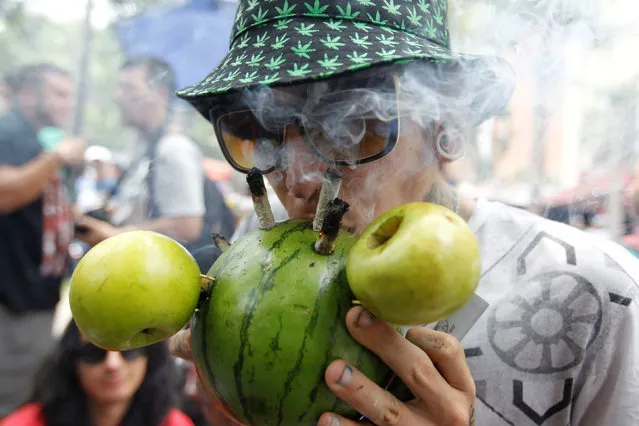 A man smokes marijuana during a global March for marijuana in Medellin, Colombia, May 7, 2016. (Photo by Fredy Builes/Reuters)