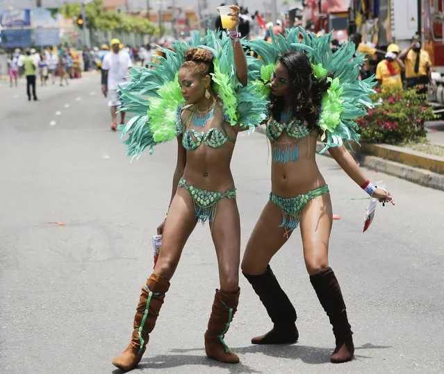 Revelers dance on a street during the Jamaica Carnival Roadmarch in Kingston, Jamaica, on April 27, 2014. The Roadmarch is the final day of the festivities of the Carnival season. (Photo by Gilbert Bellamy/Reuters)
