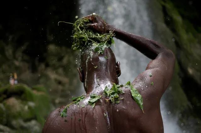 A Haitian man bathes during the celebration of the annual pilgrimage to the waterfall in Saut D'Eau, Haiti, July 14, 2019. (Photo by Andres Martinez Casares/Reuters)