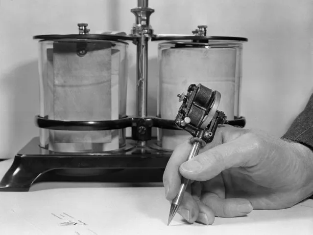 This is said to be the first commercially produced electric motor, says Ward Harris, San Francisco businessman who has a collection of Thomas Edison's inventions, February 7, 1949.  Photo shows the Edison electric pen, a stencil needle powered by the batteries in the background.  As the user writes in the usual manner, the needle jabbed holes in the paper which was used as a stencil by applying ink with a hand roller. (Photo by Ernest K. Bennett/AP Photo)