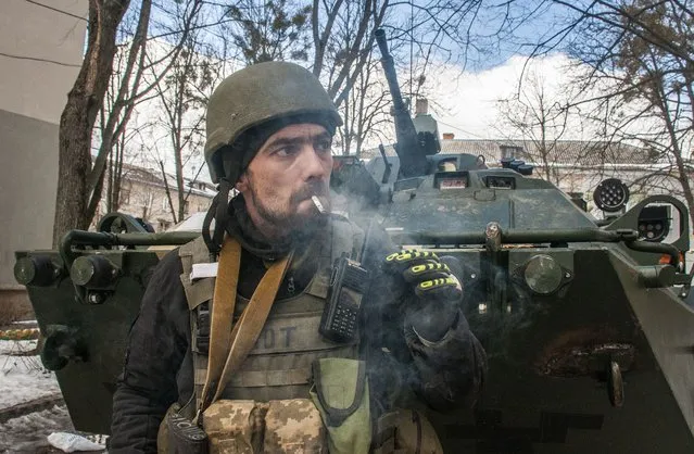 A volunteer of the Ukrainian Territorial Defense Forces smokes in Kharkiv, Ukraine, Wednesday, March 16, 2022. (Photo by Andrew Marienko/AP Photo)